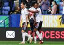 Bolton Wanderers' Victor Adeboyejo celebrates scoring his side's third goal and completing his hat trick with Paris Maghoma and Gethin Jones