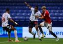Bolton Wanderers' Cameron Jerome battles with Salford City's Theo Vassell