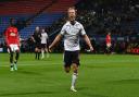 Luke Matheson celebrates Bolton Wanderers' eighth goal against Manchester United
