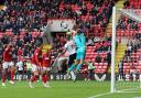 Victor Adeboyejo goes up for a header against Charlton's keeper