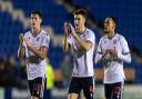 Bolton Wanderers' Eoin Toal (left) , George Thomason and Josh Dacres-Cogley applaud their side's travelling supporters at the end of the match