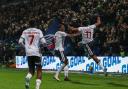 Dan Nlundulu leaps into the air to celebrate scoring Bolton's seventh goal against Exeter