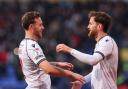 Bolton Wanderers defenders Gethin Jones and Jack Iredale celebrate a goal against Exeter