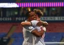 Victor Adebyejo hugs Bolton Wanderers strike partner Dion Charles