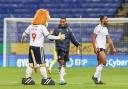 Victor Adeboyejo is congratulated by Lofty the Lion after Bolton's win against Cheltenham
