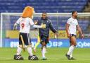 Victor Adeboyejo is congratulated by Lofty the Lion after Bolton's win against Cheltenham