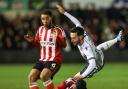 Bolton Wanderers' Josh Sheehan is fouled by Lincoln City's Timothy Eyoma with Ethan Erhahon close by