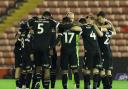 The Bolton squad in a huddle at Barnsley