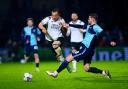 Derby County's Kane Wilson (left) and Wycombe Wanderers' Matt Butcher battle for the ball during the Sky Bet League One match at Adams Park, Wycombe