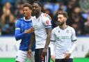 Bolton Wanderers' Ricardo Santos hugs Portsmouth's Kusini Yengi