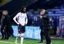 Bolton Wanderers manager Steven Schumacher talks to Ibrahim Cissoko during a break in play