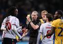 Bolton Wanderers' Ibrahim Cissoko is shown a yellow card by Referee Peter Wright for simulation