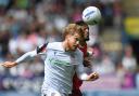 Bolton Wanderers' Luca Stephenson battles with Preston North End's Delano Burgzorg