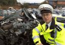 Chief Inspector Haydn Roberts with some of the vehicles that have been seized and a crushed vehicle.