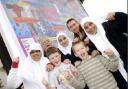 ART FOR ALL: Artist Oliver Wotherspoon, back right,  and Cllr Noel Spencer, back left, with youngsters at a community billboard off Great Moor Street, Bolton