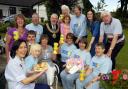 Party time: Sue Irwin, front left, the face of Marie Curie, with garden party hosts Kath White (fourth left) and Alison Hargreaves, back left, along with volunteers, visitors and the Mayor and Mayoress of Bolton, Cllr Norman Critchley and his wife,