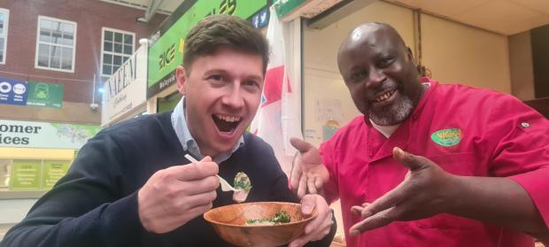 The Bolton News: StevE Thompson tries 'lamb balls' cooked up by Alain Job at Nkono at Bolton Market