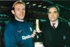 Mark Patterson collects a bottle of Champagne for winning the club's Player of the Month before a game against Brescia.