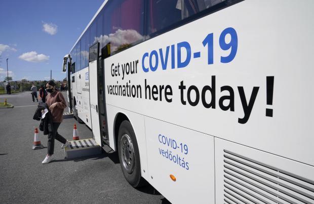 A Covid vaccination bus in Bolton (Image: PA)