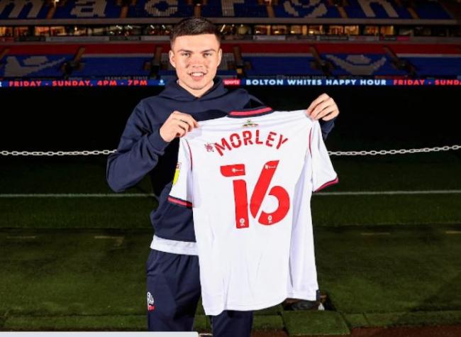 Aaron Morley poses with his new Bolton shirt. Picture courtesy of BWFC.