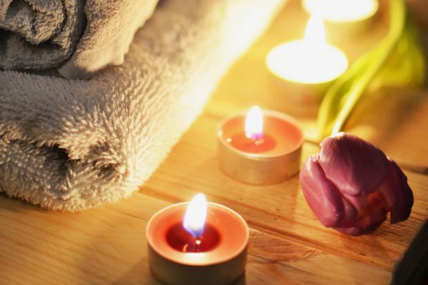 The Bolton News: A pile of towels, candles and a tulip. Credit: Canva