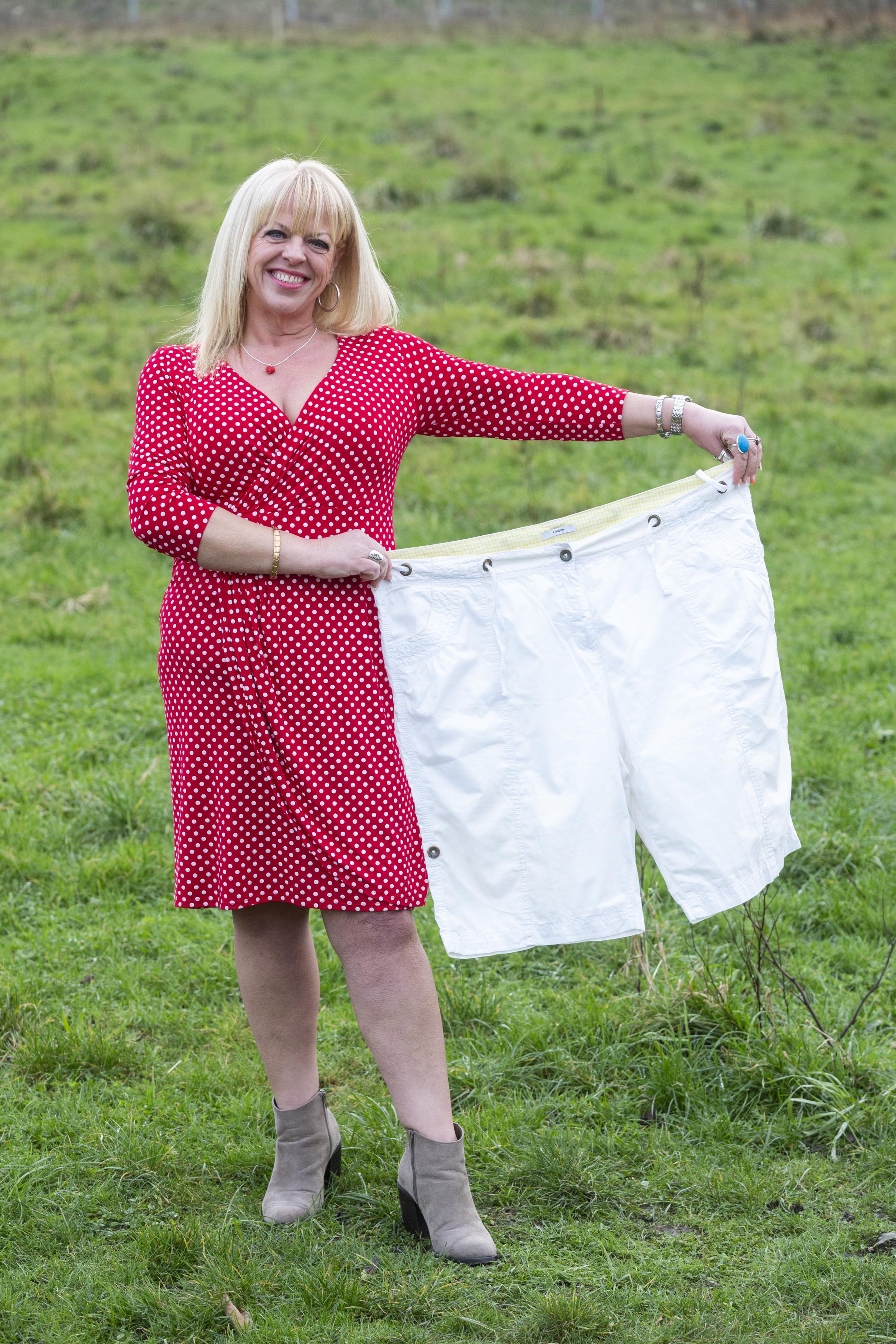 Karen Fay holds her old size 24 shorts she use to wear