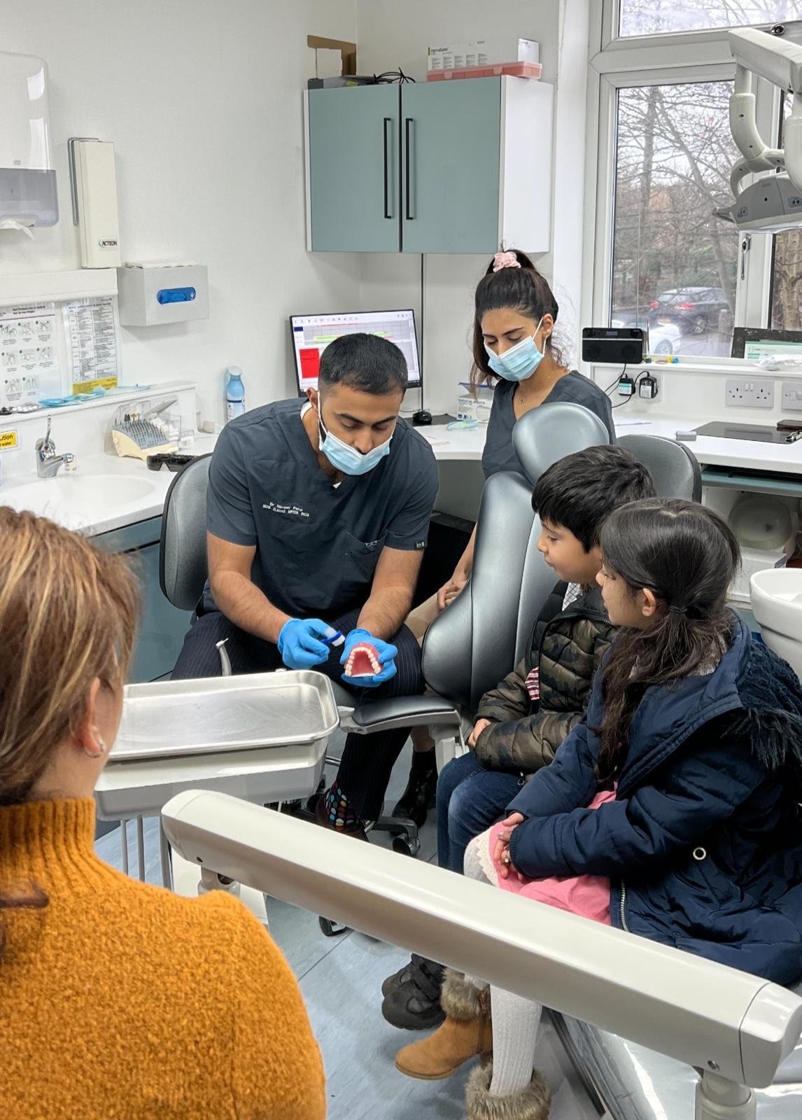 Dr Naveed Patel showing refugee childern the best ways for dental hygiene