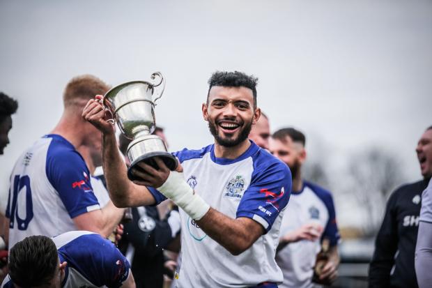 Liam MacDevitt celebrates with the NWCL First Division North trophy Picture: Laura Fenton