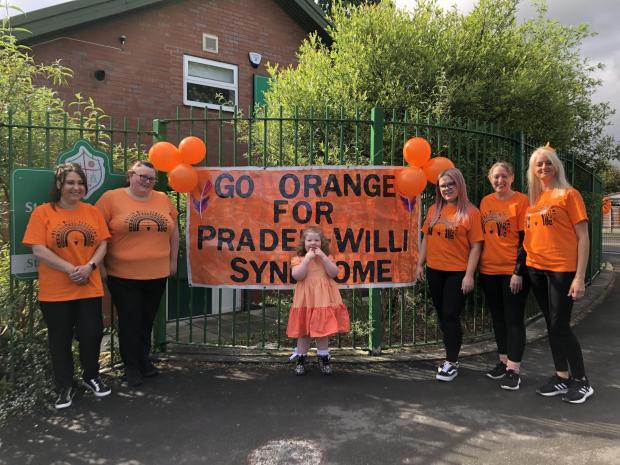 The Bolton News: Nursery staff with Ruby Hill-Barlow, all dressed in orange