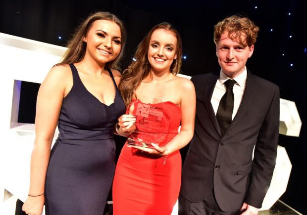 The Bolton News: Ellie Entwistle of Bring Digital, centre, with her Young Person/Apprentice of the Year award given by Aimee Holden and Edward Halsall of Stateside at Bolton Business Awards 2018