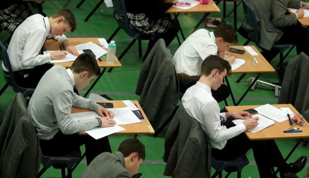 The Bolton News: An AQA walkout could delay GCSE and A Level results. Picture: PA