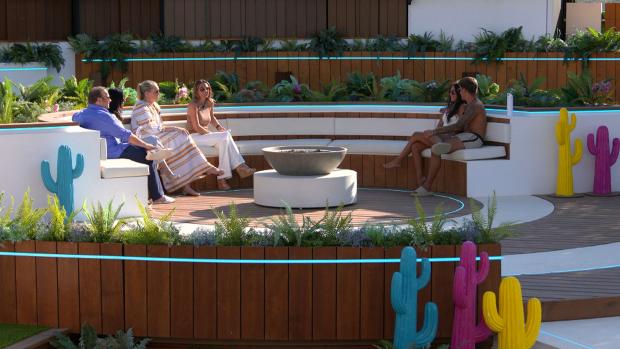 The Bolton News: Gemma and Luca at the fire pit with their families. Love Island continues tonight at 9pm on ITV2 and ITV Hub. Episodes are available the following morning on BritBox. Credit: ITV