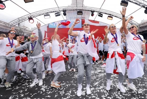 The Bolton News: England players sing Sweet Caroline on stage during a fan celebration to commemorate England's historic UEFA Women's EURO 2022 triumph in Trafalgar Square. Credit: PA