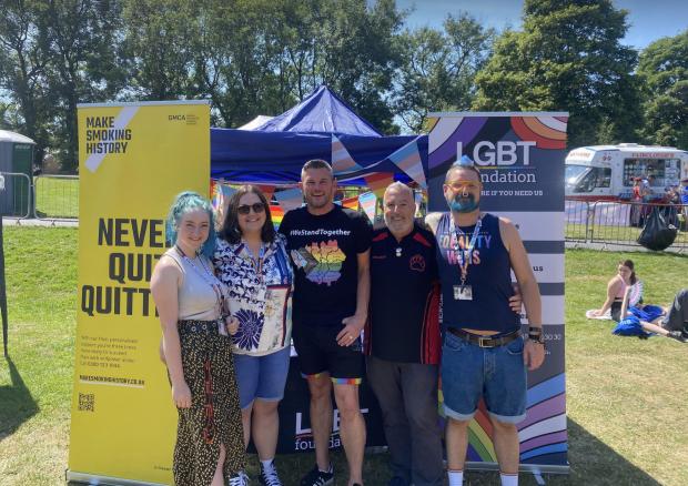 The Bolton News: LGBT Foundation representatives at their stall at a Pride event