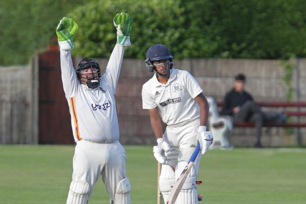 HOWZAT! Farnworth wicketkeeper Simon Booth successfully appeals the wicket of Blackrod’s Nikhil Patel. Picture by Harry McGuire