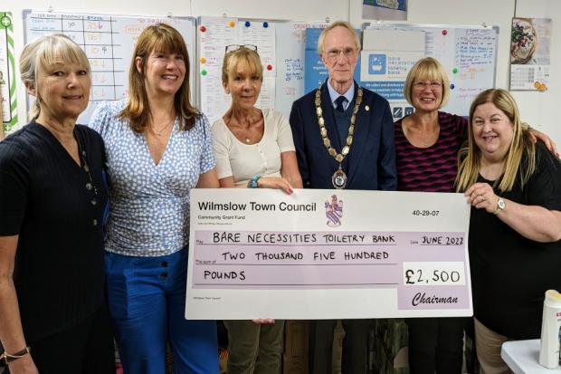 Cllr Frank McCarthy, chairman of Wilmslow Town Council, presents a £2,500 community grant to Bare Necessities Toiletry Bank