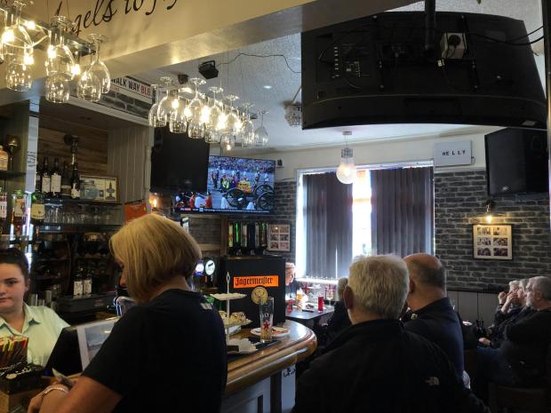 Bolton News: Pub customers watching funeral on television