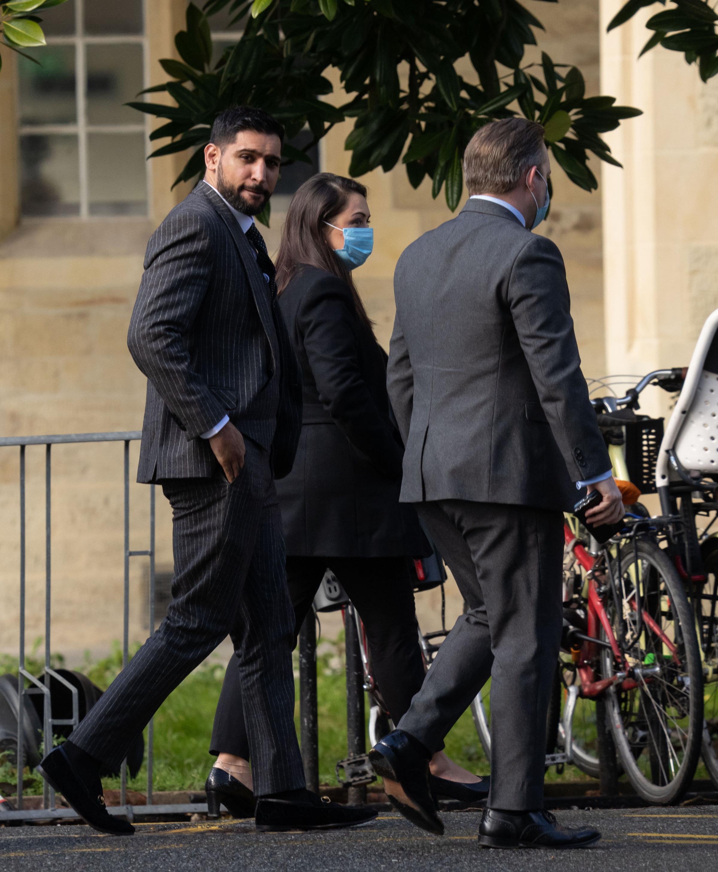 Former world boxing champion Amir Khan, (left) arrives at Snaresbrook Crown Court, in east London, where three men are accused of robbing the boxer of a diamond watch at gunpoint. Khans 72,000 custom-made Franck Muller watch was stolen in High Road,
