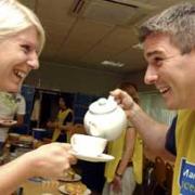 ANYONE FOR TEA? Donald Fowler, Managing Director of Premex, Horwich, serves employee Zoe Dean with a cup of tea during the company’s charity Marie Curie tea party
