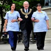 STEPPING OUT: Marie Curie nurses Sue Irwin, left and Pam McCarthy help The Mayor of Bolton, Cllr Norman Critchley launch the Mayor’s Mile event which will be held in Victoria Square, Bolton, next year