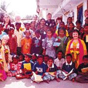 <li> Melanie Price, Betty Price and Rita Varey are pictured with some of the Indian orphans who have benefited from the SunFlowerTrust <li> Betty Price with a young Indian boy <li> The group cross a river during the recent trip to India <li> Rose Roberts