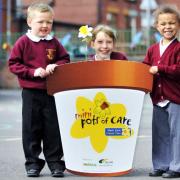 FLOWER POWER: St Thomas CE School pupils Lewis Jones, aged five, Sarah Kemp, aged 10 and Racheal Bob-Manuel, aged five who helped to launch the Marie Curie mini pots scheme in which pupils planted a daffodill bulb in return for a donation