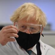 Prime Minister Boris Johnson holds a vial of the Oxford/AstraZeneca Covid-19 vaccine. Photo: Paul Ellis/PA Wire.