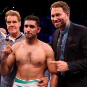 Amir Khan celebrates with trainer Joe Goossen (left) and promoter Eddie Hearn after beating Samuel Vargas on points after their Welterweight contest at Arena Birmingham, Birmingham