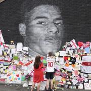 A mural of Marcus Rashford which had been defaced is adorned with messages of support (Danny Lawson/PA).