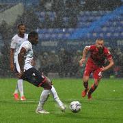 Amadou Bakayoko scores from the penalty spot for Wanderers against Liverpool.