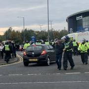 Nine people have been banned from Bolton after trouble during the club's clash with Wigan