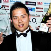 TOASTING SUCCESS: Peter Wu, of The Chinese Buffet, with the Business Person of the Year award — and champagne!
