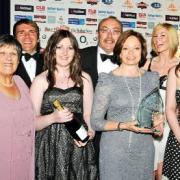 FAMILY ETHOS: Marilyn Taylor, far left, and Bernice Peers holding the award, are pictured with staff from The Peers Group, Bolton, celebrating their achievement