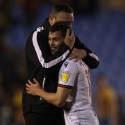 Ian Evatt embraces Dion Charles after his winning goal against Shrewsbury Town
